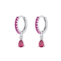 Vue macro de boucles d'oreilles argentées avec zircon rouge poire et petites pierres - Goutte Argent Rouge