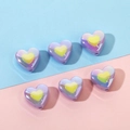Macro shot of iridescent purple heart beads with yellow centers for DIY jewelry making - Purple