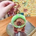 Cute capybara plush keychain wearing a green snake hoodie with a bell attachment - Snake Headwear 2.0