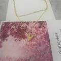 Layered gold necklace featuring a dainty chain and paperclip link with a crystal letter V - Letter V