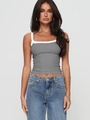 Close-up of grey lace trim camisole paired with blue denim jeans in a studio shot - Gray