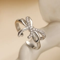 Detailed view of silver bow ring featuring micro-paved zircons on minimalist stand - Adjustable Open / Silver Pave Bowknot