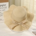 Chic beige straw sun hat featuring a wavy brim and matching bow for beach vacations - Lotus Knot Beige