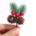 Detailed view of mini Christmas pine pick with red berries and brown pinecone decor - Two-leaf Pine with Double Natural Cones