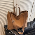 Large brown canvas tote bag with adjustable strap and top handles for commuting - Brown