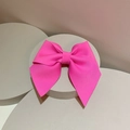Detail of rose pink textured ribbon bow hair clip on a minimalist gray pedestal display - Hair Clip / Rose Red