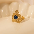 Macro detail of crown ring in gold with blue stone on decorative shell plate - Blue Gem-Gold