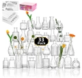 Bulk set of 33 assorted clear glass bud vases with unique embossed patterns on white background - Clear (33 Pieces Set)