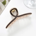 Detail view of a large dark brown and gold striped shark hair claw clip on a white table - Dark Coffee-11cm