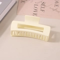Matte beige rectangular large hair claw clip placed on books in a minimalist setting - #43 Glossy Milky White - 10.5cm / Bulk (No Packaging)