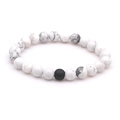 Detailed macro view of white turquoise beads with grey veins and black lava stone bead - Howlite + Matte Black
