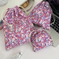 Three-piece floral drawstring pouch set in various sizes for travel skincare storage - Pink Flower
