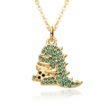 Detailed macro shot of a golden dinosaur necklace with sparkling green zircon stones - Green Dinosaur Shape (D570)