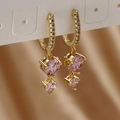 Detail of gold drop earrings with pink zircons on champagne silk background - Gold Color Pink Zirconia