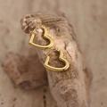 Detail showing the hammered texture of golden heart-shaped stainless steel earrings - EH369-Minimalist Heart