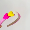 Detailed view of sweet pink sponge headband with colorful pink yellow and white 3D hearts - Pink Hoop