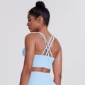 Close-up of the sky blue sports bra featuring cross-back straps and soft brushed fabric - Sky Blue