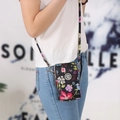 Vertical mini crossbody phone bag with vibrant floral print and adjustable strap - Flowers in Bloom