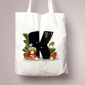 Christmas canvas tote bag featuring large letter K with Santa and festive holiday graphics - Letter K