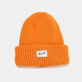 Close-up of orange ribbed knit beanie with white AQER logo patch on the folded cuff - Orange