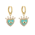 Detail of gold heart earrings with evil eye enamel and shimmering zircon crystals - Teal Enamel Heart