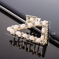 Detailed view of a gold triangle hair claw with white pearls and sparkling rhinestones - Half Rhinestone Half Pearl Triangle 5CM Claw Clip