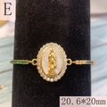 Macro shot of Virgin Mary religious charm with colorful zircon stones and gold finish - Style E-White