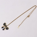 Collier en perles MIYUKI fait main avec pendentif nœud noir et doré sur chaîne dorée - Nœud / Noir