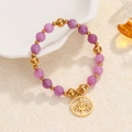 Natural purple stone bead bracelet with gold Tree of Life charm on a beige background - Purple Beads-Gold Tree of Life Charm