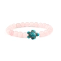 Detailed view of pink crystal beads bracelet featuring a turquoise sea turtle charm pendant - Rose Quartz