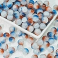 Macro detail of 10mm blue and brown marbled glass beads for DIY jewelry making - Brown Blue (10mm Protein Jade)