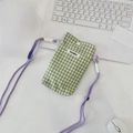 Macro shot of green gingham phone pouch with purple adjustable cord and white button closure - Green Plaid