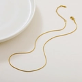 Elegant gold moonstone necklace pendant featuring a Ruyi lock design on a clean white tray - 09 Snake Chain