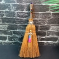 Detail of a brown witch broom with natural crystals, moon charm and sun pendant - Amethyst + Sun + Blue-Green Crystal