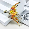Elegant phoenix brooch with gold plating, yellow gradient enamel, and sparkling crystals - Gold