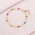 Detailed macro of gold-plated stainless steel bracelet featuring colorful heart-shaped charms - Colorful Hearts
