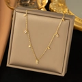 Detailed shot of golden link necklace with rectangular zircons and square charms - Crystal Square Necklace / Gold