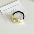 Minimalist black elastic hair tie featuring a large polished gold metal arc ornament - Semi-oval / Gold