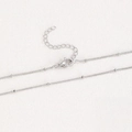Close-up of silver-plated copper bead chain with lobster clasp and extension link - Copper / Bead Chain / Silver