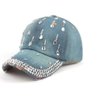 Close-up of blue denim baseball cap with sparkling rhinestones and drop crystal details - Denim Blue
