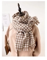 Houndstooth cashmere-feel scarf in camel and white tied on a model wearing a coat - Large Houndstooth Khaki