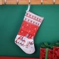 Knitted red Christmas stocking with snowflake and Santa sleigh patterns on a wooden hook - Red Background Pattern Sock