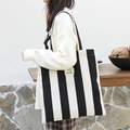 Vertical black and white striped canvas tote bag with shoulder straps and woven label - Black