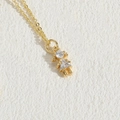 Exquisite golden necklace featuring a girl pendant with sparkling round and triangle zircons - Little Girl Zirconia / 14K Gold
