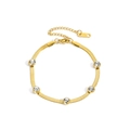 Elegantes goldenes Edelstahl-Schlangenarmband mit fünf eingelegten Zirkonia-Steinen - Gold