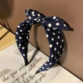 Navy blue polka dot headband with sweet bow design on decorative art card background - Navy Blue