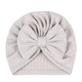 Detail of light grey ribbed knit fabric and large bow on baby turban hat - Gray