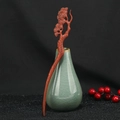 Detailed view of hand-carved sandalwood hair stick with pine branch motif in red-brown finish - Pine Tree Shape (F2023785)
