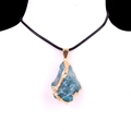 Blue irregular raw stone necklace pendant with gold trim on black woven cord - Apatite