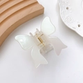 Elegant cream-white acetate butterfly hair claw clip on a minimalist display - Gem White